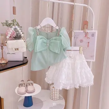 Одежда для девочек Лето 2023, новая Корейская версия, модные Детские топы и юбка принцессы с коротким рукавом и бантом, комплекты из двух предметов, милые